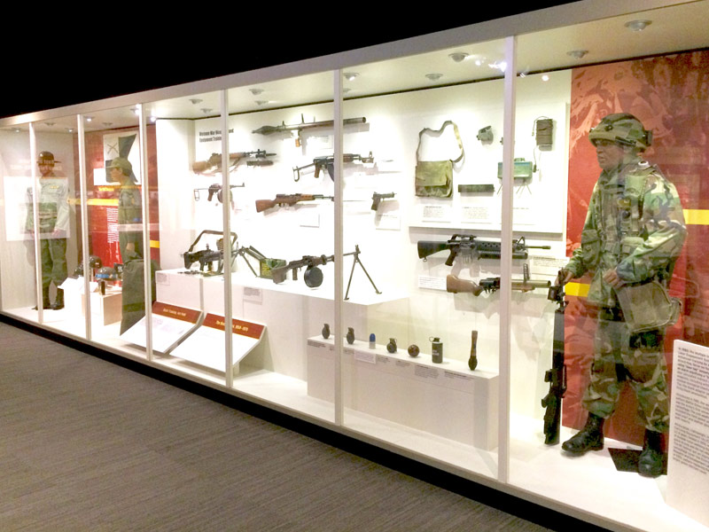 Museum artifacts in a glass enclosure at the Fort Polk Museum.